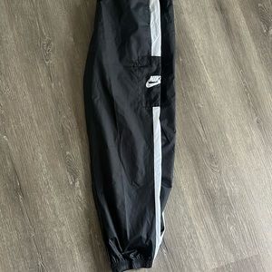 NIKE black track pants.